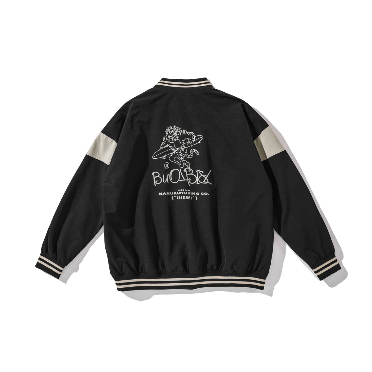 Back view of a black varsity jacket with cream sleeve panels, striped trim and a large cream graphic.
