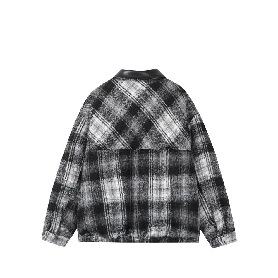 Back view of a black, gray, and white plaid jacket with a black collar and snap cuffs.