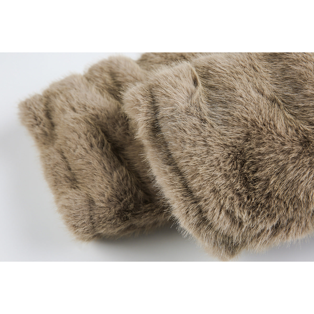 Close-up of a thick, rounded cuff on the taupe-brown faux-fur coat.