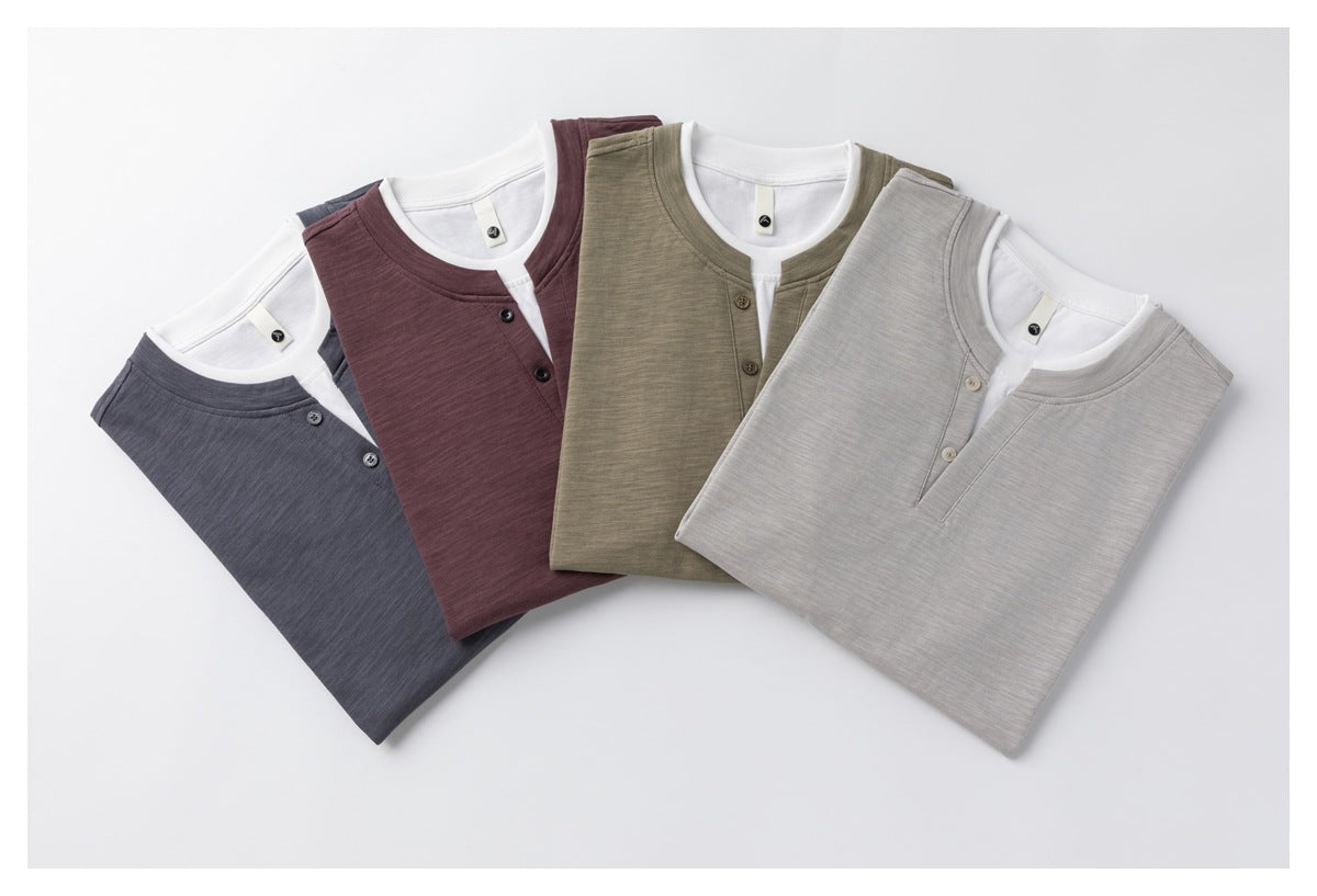 Four folded short-sleeve T-shirts in dark gray, plum, khaki and glacier gray with white layered necklines