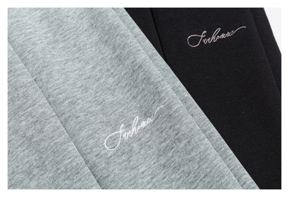 Close-up of script embroidery on gray and black fabric colorways.