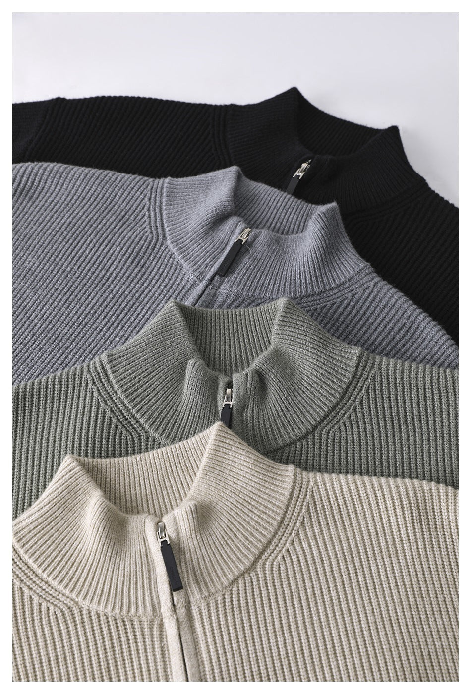 Close-up of four rib-knit zip sweaters in black, gray, olive, and beige, showing their collars and zipper details.