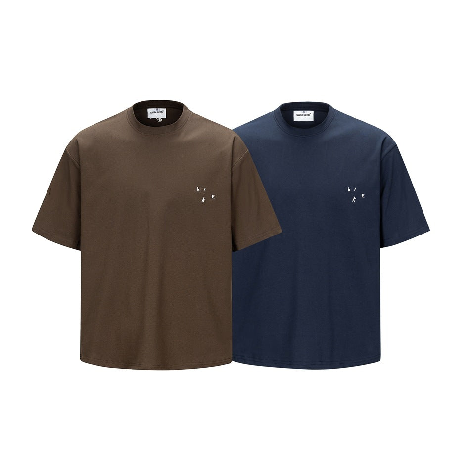 Front view of two short-sleeve crew-neck T-shirts, one brown and one navy, with small white chest embroidery.