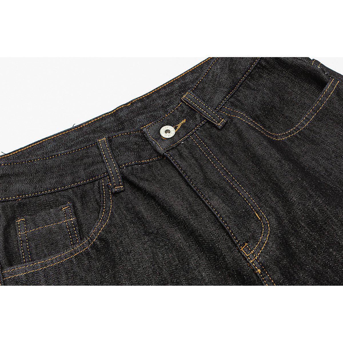 Close-up of dark indigo jeans showing the front waistband, button, belt loops, fly stitching and small pocket.