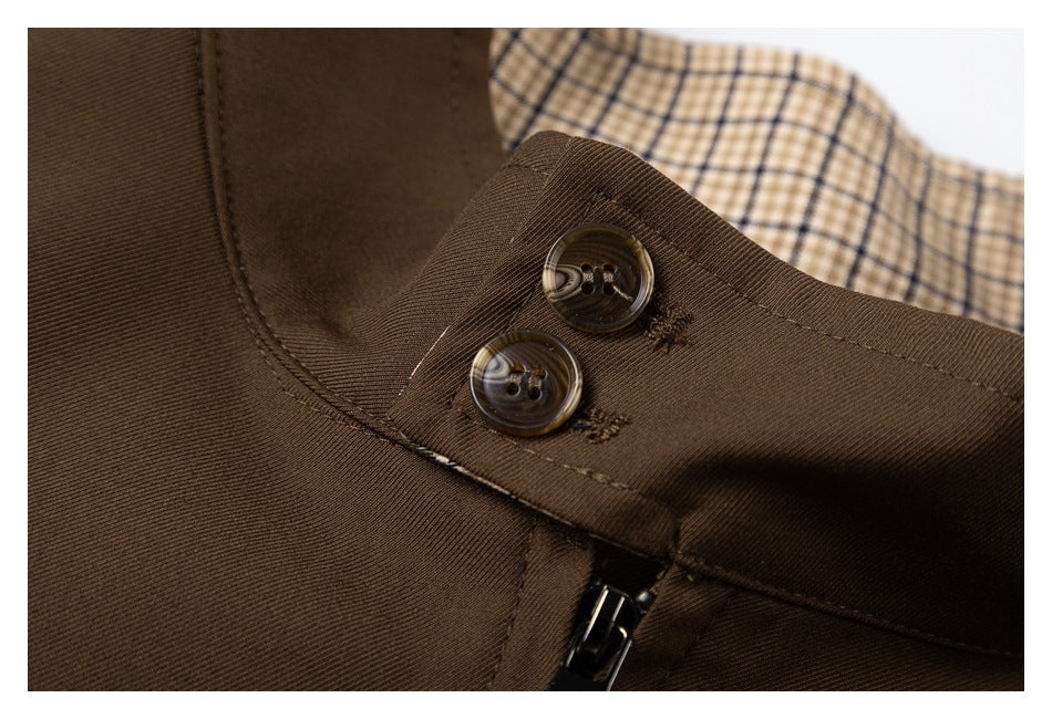 Close-up of two dark buttons on the brown collar flap with checked lining visible behind.