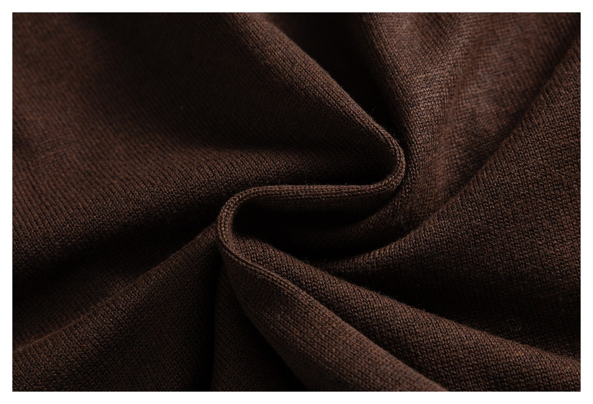 Macro view of the dark brown knit fabric, showing its fine texture and folded drape.