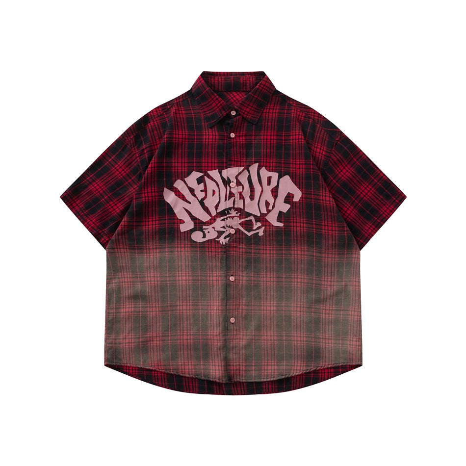Red and black plaid short-sleeve button-up shirt with faded hem gradient and pink graphic print, front view
