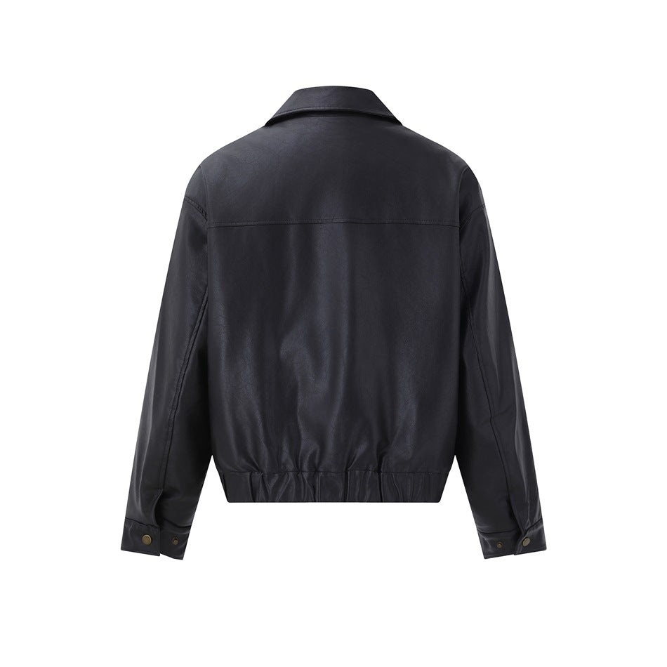 Back view of a black jacket with a pointed collar, long sleeves, a gathered hem, and snap cuffs.