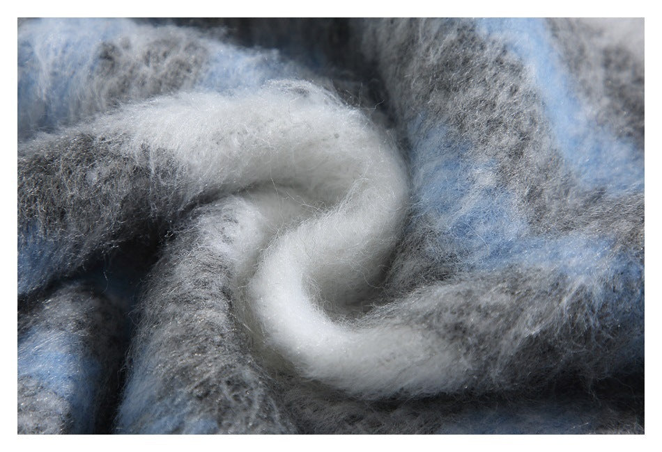 Close-up of fuzzy knit fabric in gray, blue, and white.