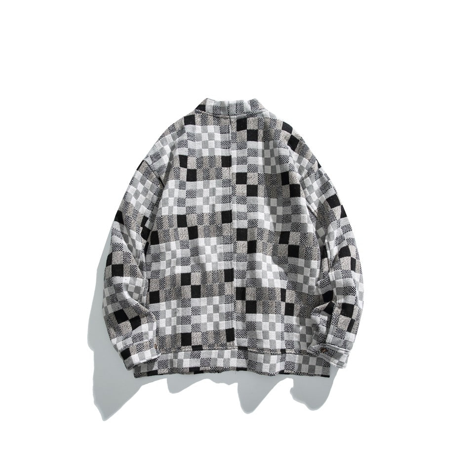 Back view of a black, gray and white patchwork-check long-sleeved jacket with a short stand collar and button cuffs.