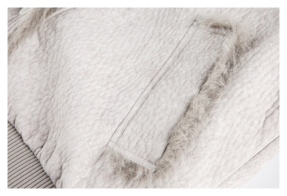 Close-up of a light beige jacket pocket with fuzzy trim and a ribbed knit edge.