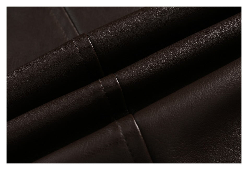 Close-up of dark brown pebbled garment material with overlapping stitched panels.