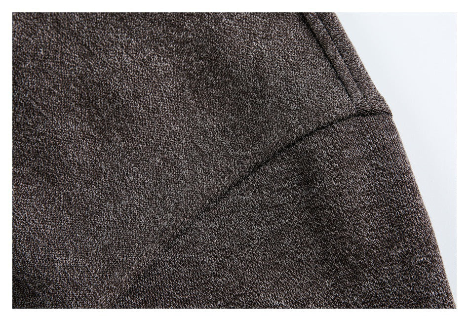 Close-up showing the seam and textured brown fabric of a jacket.