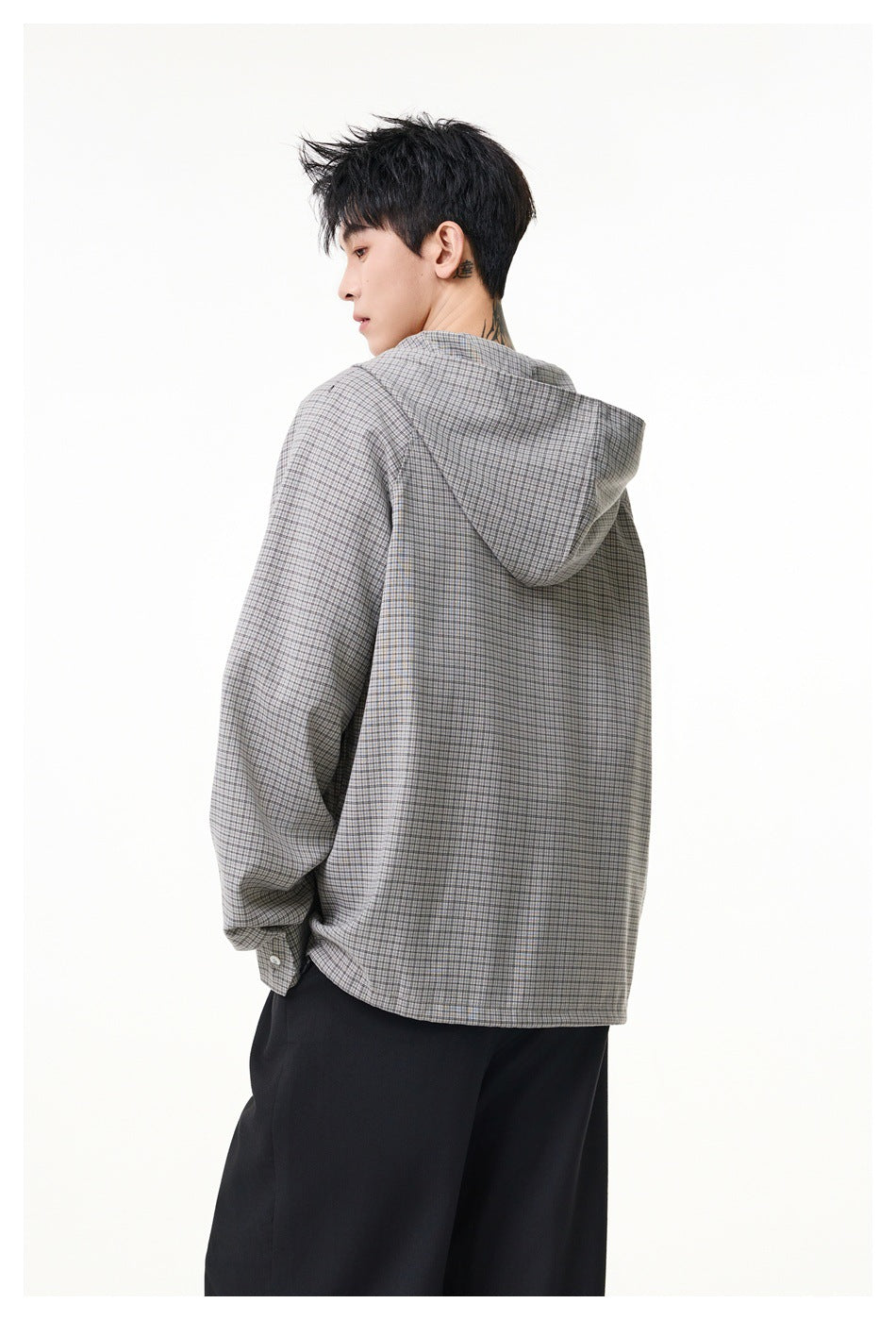 Three-quarter rear view of a model wearing a gray checked hooded pullover.