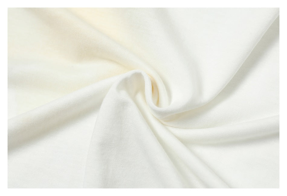 Close-up of white fabric gathered into a twist, showing its smooth surface and folds.