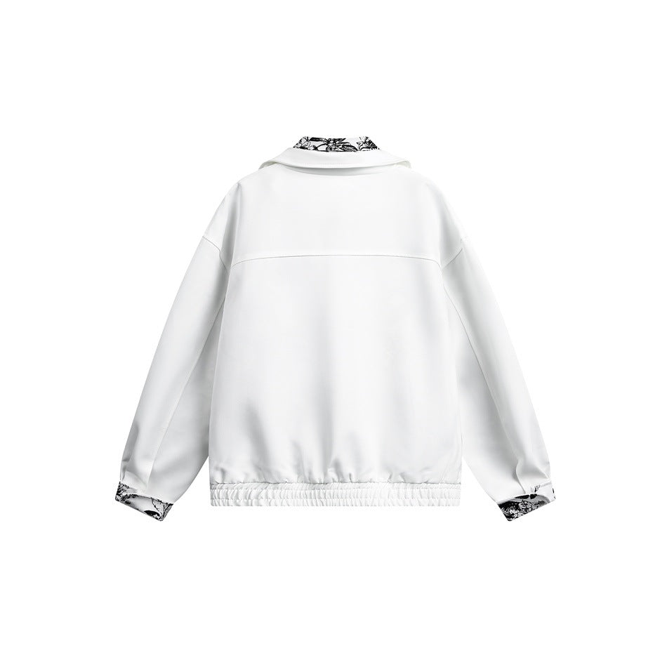 Back view of a white jacket with an elastic hem and black-and-white botanical print at the collar and cuffs.