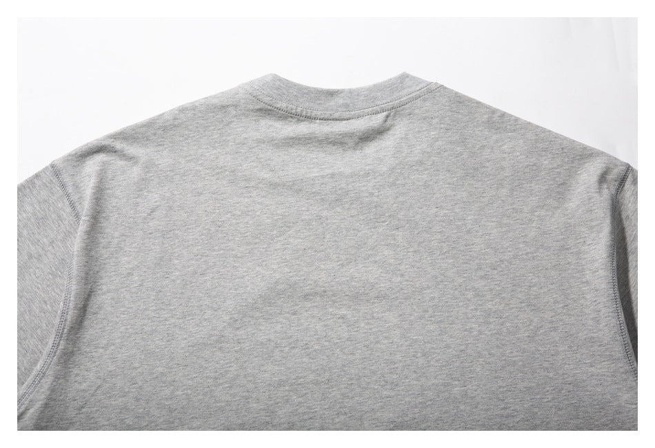 Close view of the plain gray T-shirt's back neckline, shoulders, and upper back.