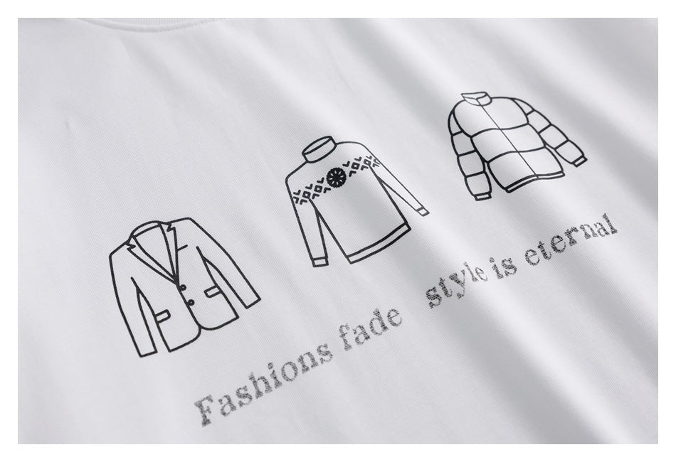 Close-up of a white shirt with black line drawings of jackets and the printed phrase “Fashions fade style is eternal.”