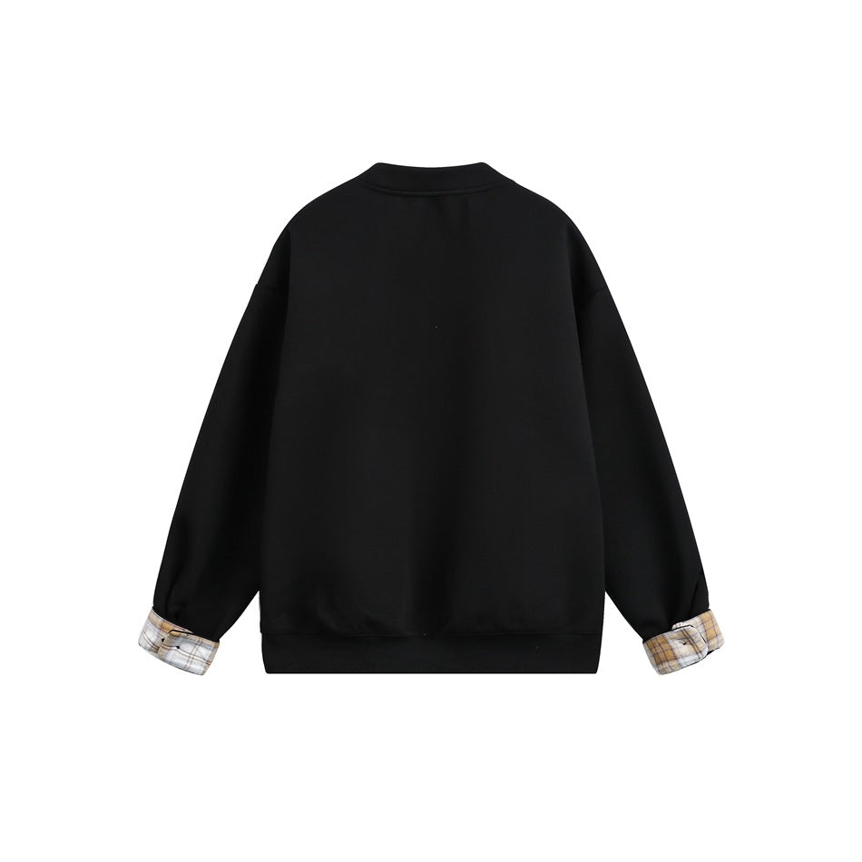 Back view of a black jacket with long sleeves, a ribbed hem, and plaid turn-back cuffs.