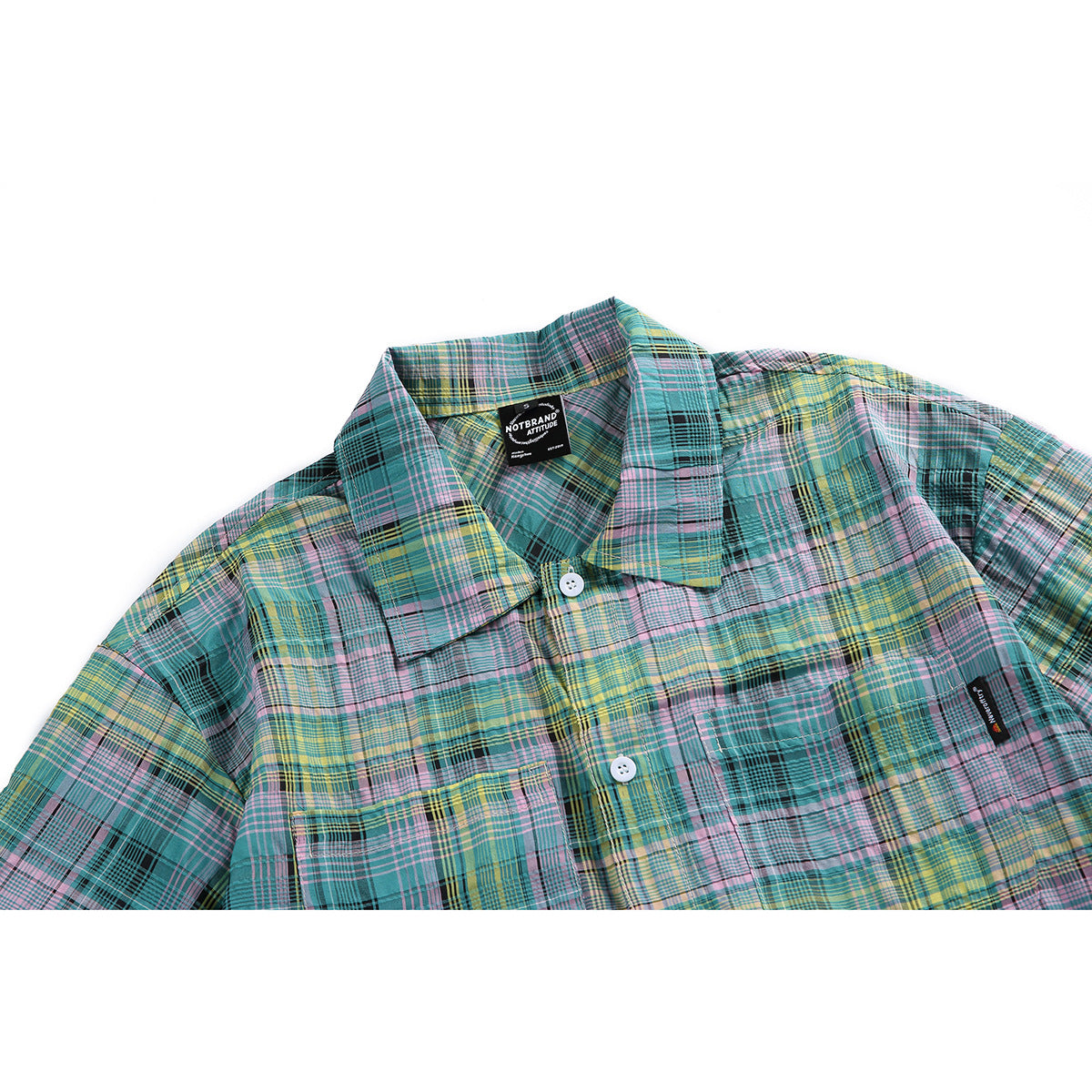 Cropped front view of a teal, pink, yellow and black plaid button-up shirt with a collar and chest pocket.