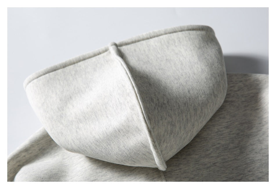 Close-up of the light gray marled sweatshirt hood, showing its edge stitching and shape.