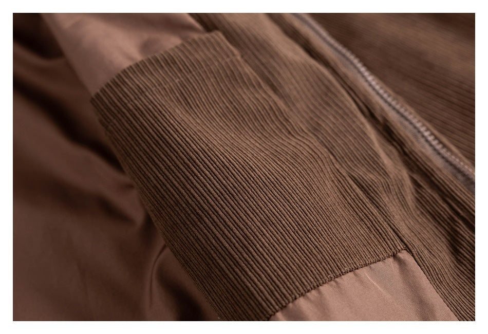 Close-up of a brown jacket sleeve with a wide ribbed panel and adjoining smooth fabric.