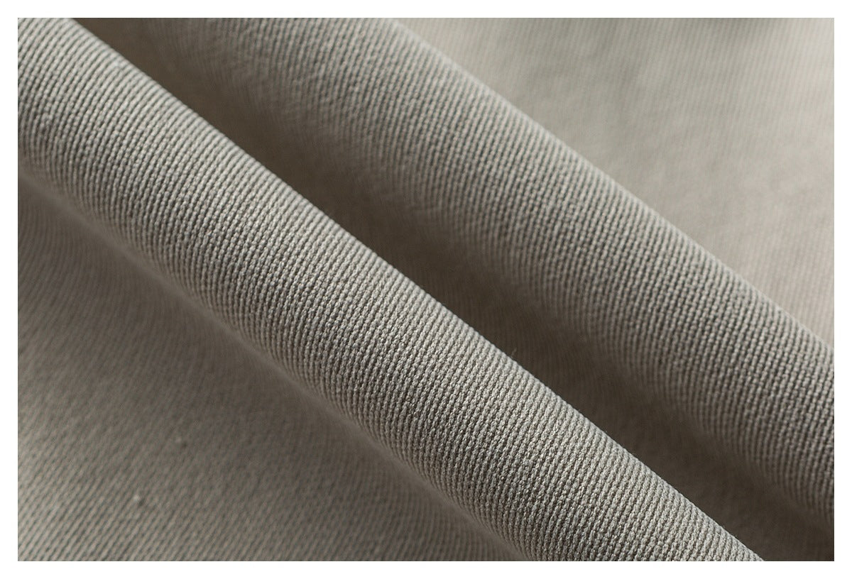 Close-up of draped taupe-gray fabric with a pronounced ribbed texture and soft folds.