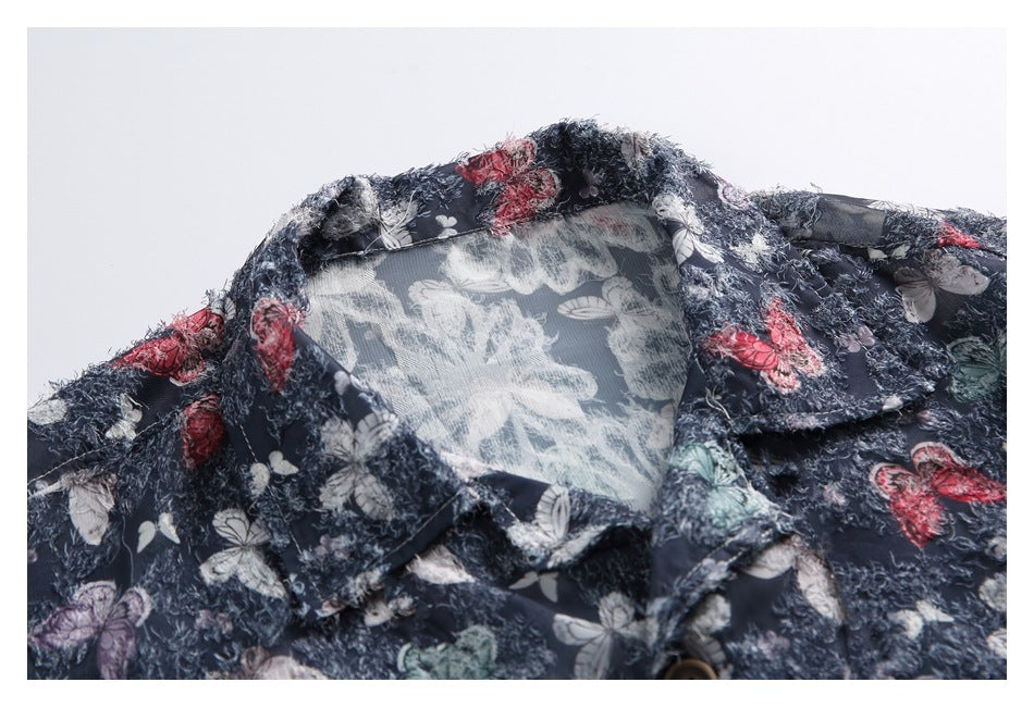 Close-up of the navy butterfly-print shirt's collar, showing its textured fabric and inner facing.