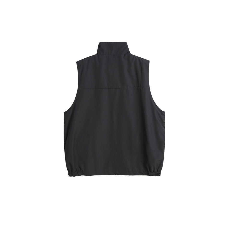Back view of a black sleeveless vest with a stand collar, back yoke seam and gathered hem.