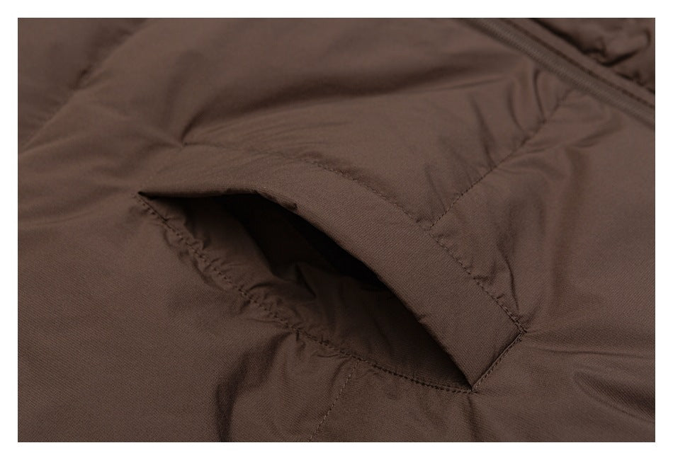 Close-up of a pocket opening on brown stitched garment fabric.
