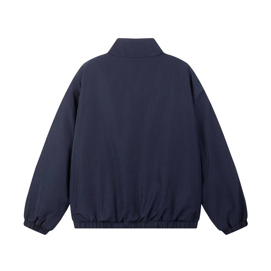 Back view of a navy jacket with a raised collar and elasticated cuffs and hem.