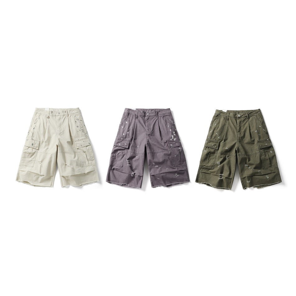 Three distressed cargo shorts shown from the front in cream, muted purple, and olive.