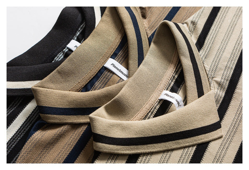 Close-up of striped T-shirt collars and sewn-in neck labels in beige, navy, black, and white colorways.