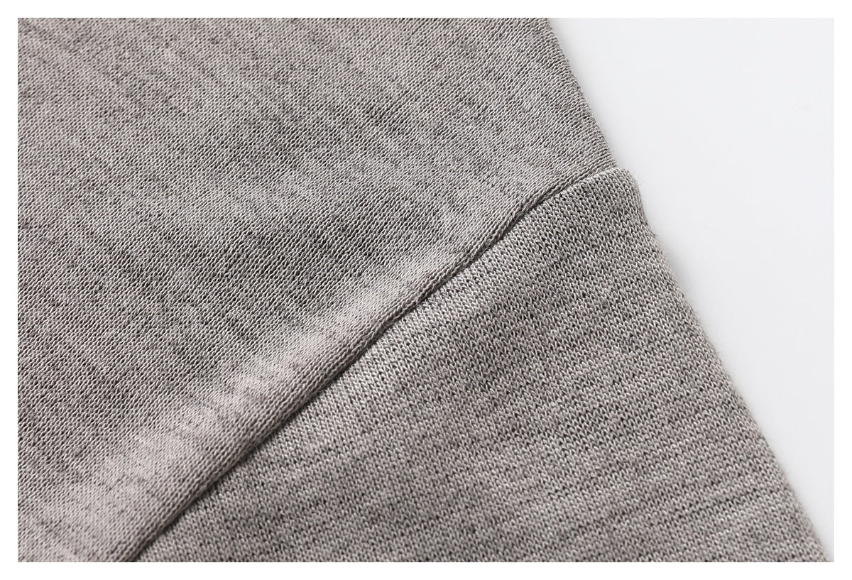 Close-up showing the gray T-shirt knit texture and a stitched seam.