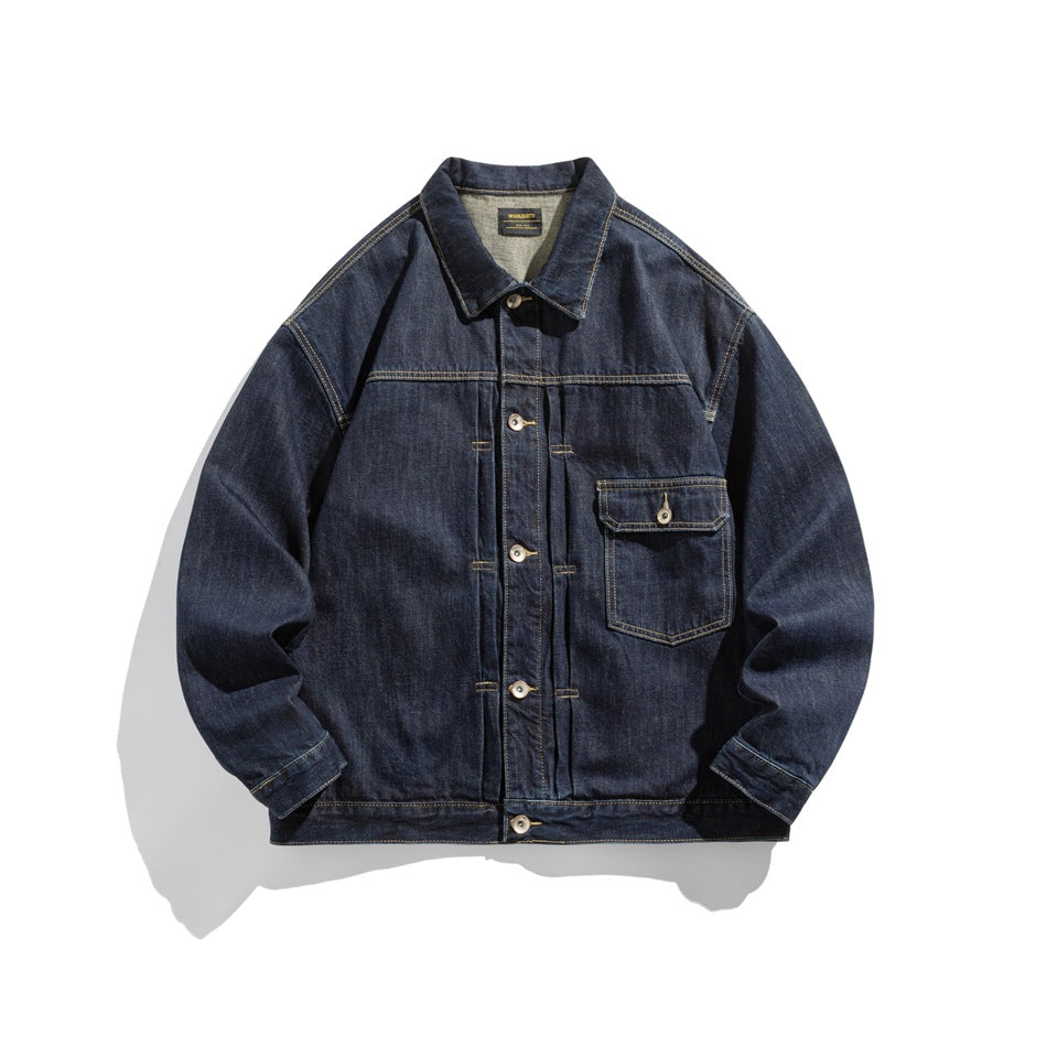 Dark indigo denim jacket flat lay, front view, with chest flap pocket, pleated front and contrast topstitching