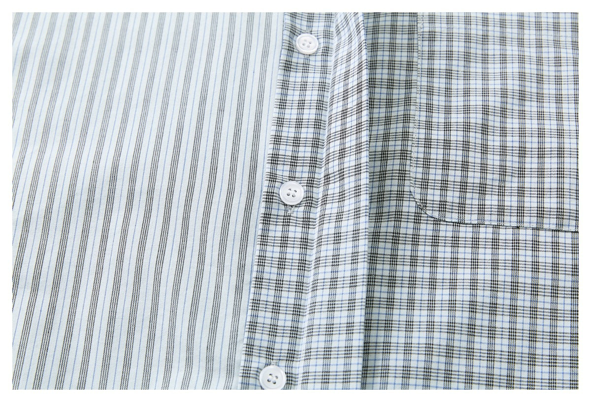 Close-up of the shirt front, showing white buttons, a plaid pocket, and contrasting fine vertical stripes.