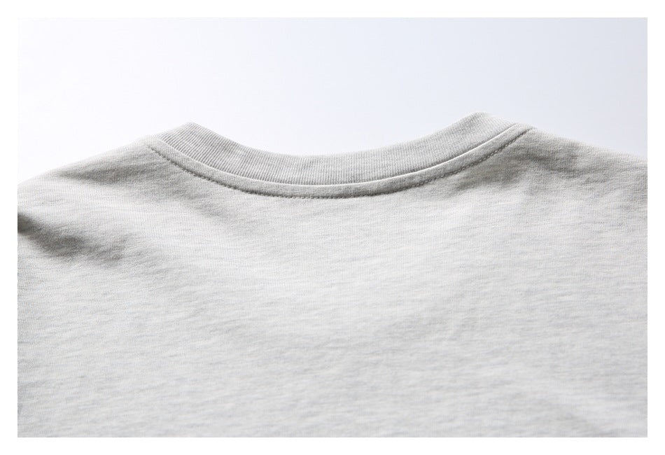 Close-up of the back neckline and shoulder area of a light gray melange T-shirt.