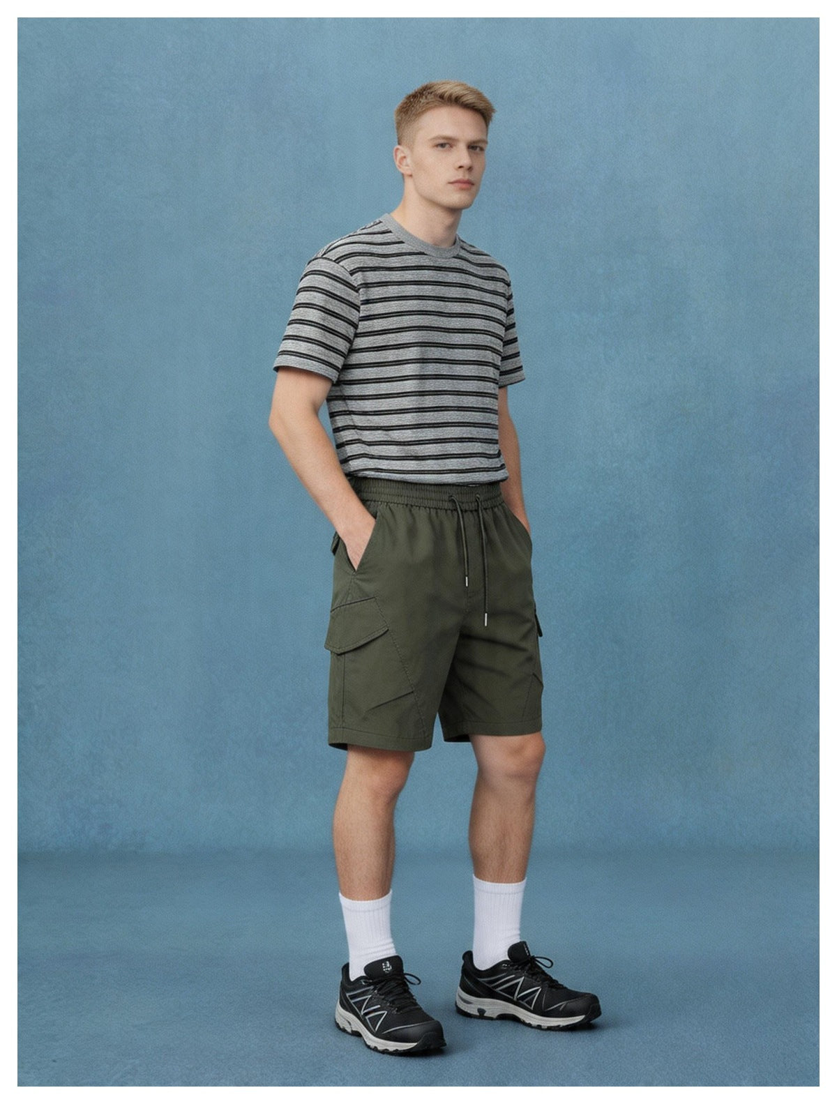 Model wearing olive cargo shorts with an elastic drawstring waist, styled with a gray striped T-shirt.