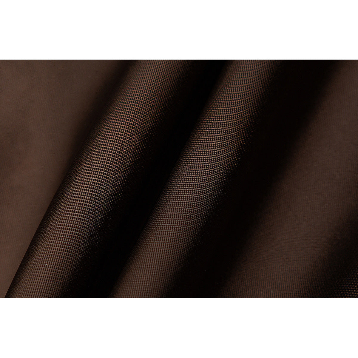 Extreme close-up of the dark brown jacket fabric and its fine woven texture.