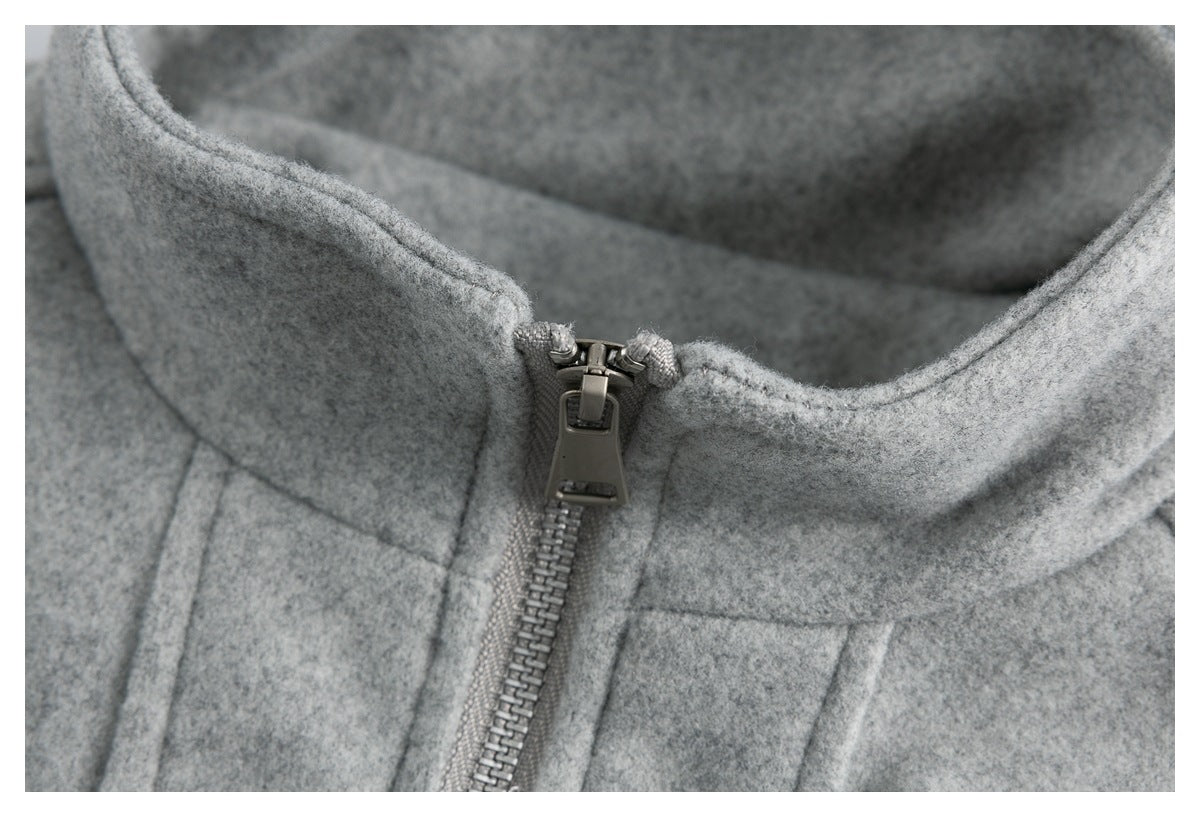 Close-up of the gray jacket's metal zipper pull and stand collar.