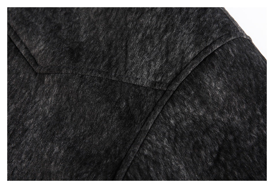 Close-up of the charcoal heather jacket fabric and curved shoulder seam.