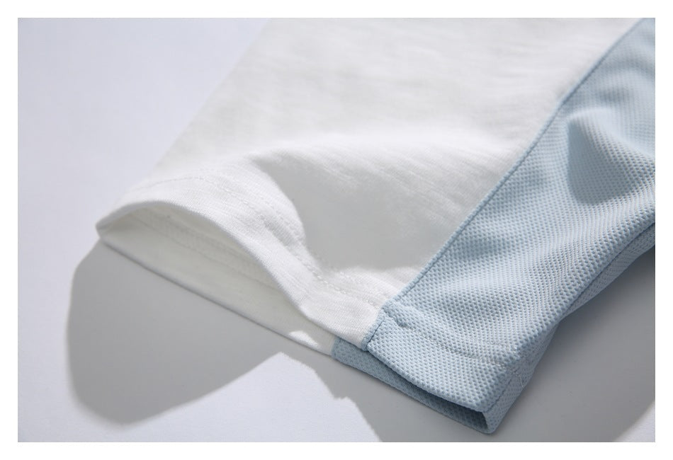 Close-up of the white T-shirt's sleeve hem beside a pale blue mesh side panel.