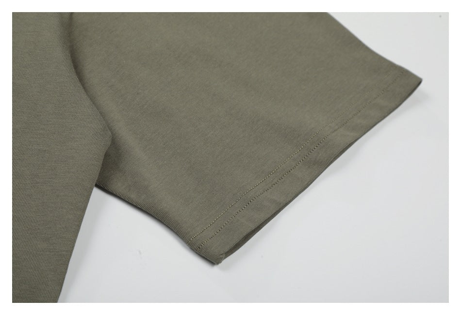 Close-up of an olive-gray short sleeve showing its double-stitched hem.
