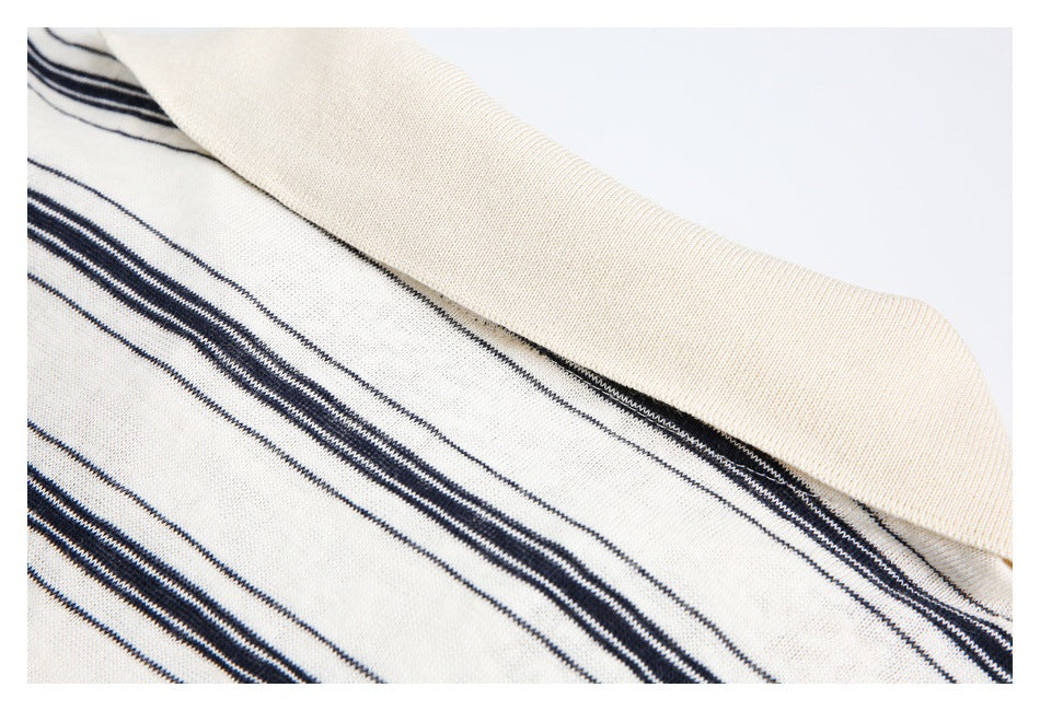 Close-up of a cream ribbed collar against cream knit fabric with navy stripes.