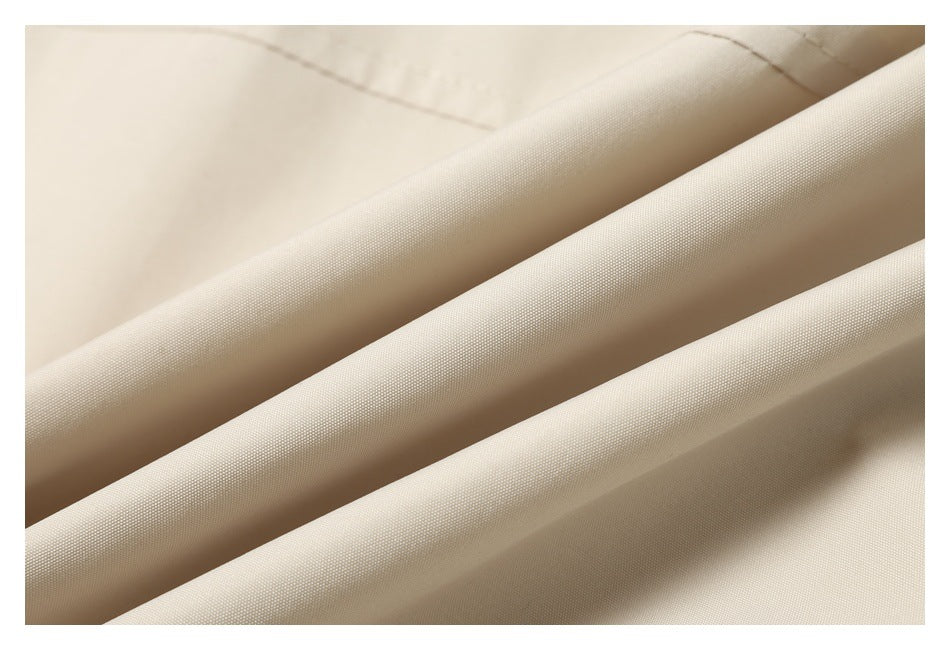 Macro view of the fine woven texture and folds of beige fabric.