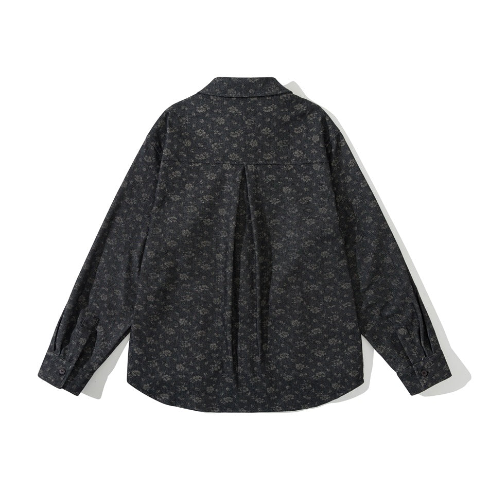 Back view of black floral-pattern shirt jacket with yoke, center box pleat and button cuffs
