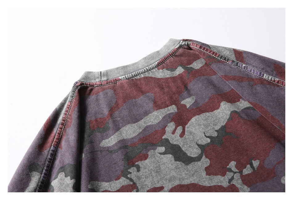 Close-up of the back neckline and shoulder seams on a maroon, gray, and dark camouflage shirt.