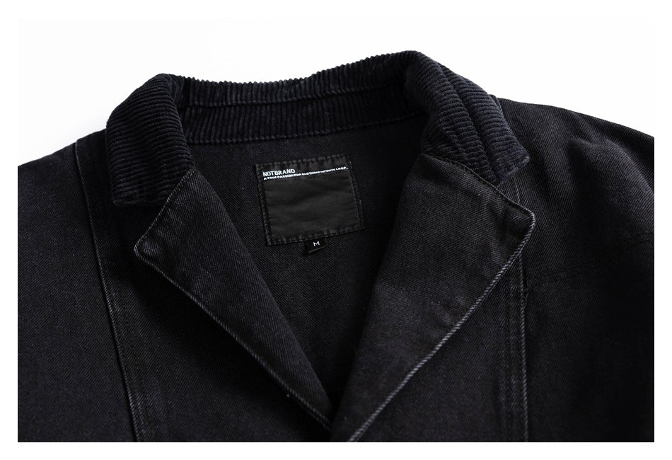 Black jacket collar and lapels with a sewn neck label, shown close up.