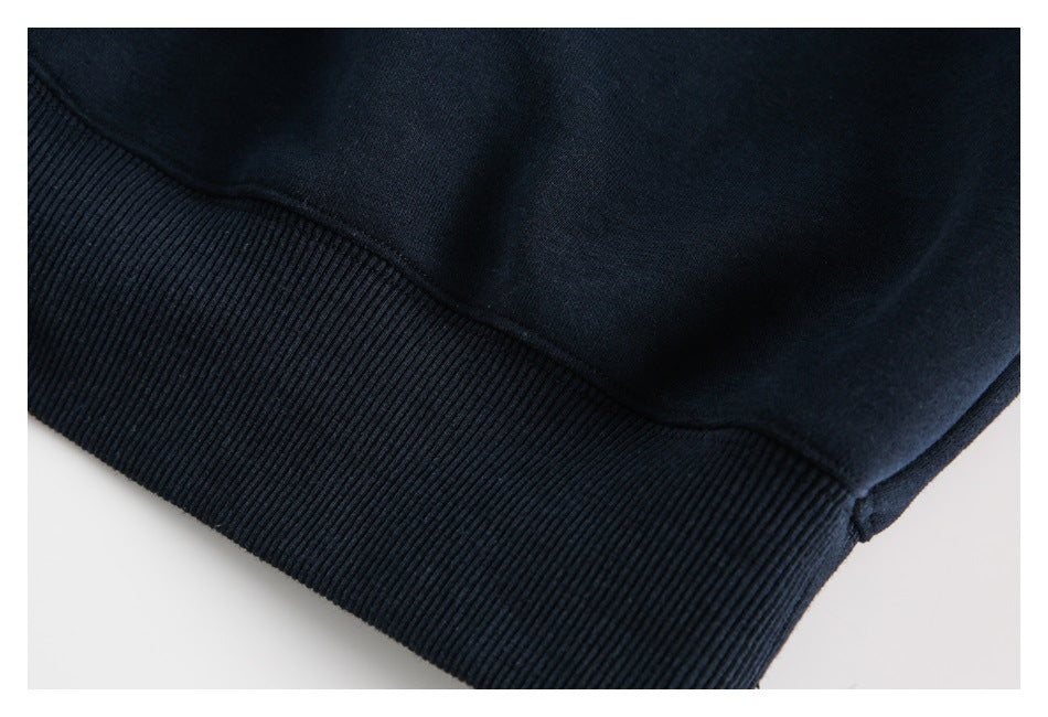 Close-up of the dark navy sweater's ribbed hem and adjoining fabric.