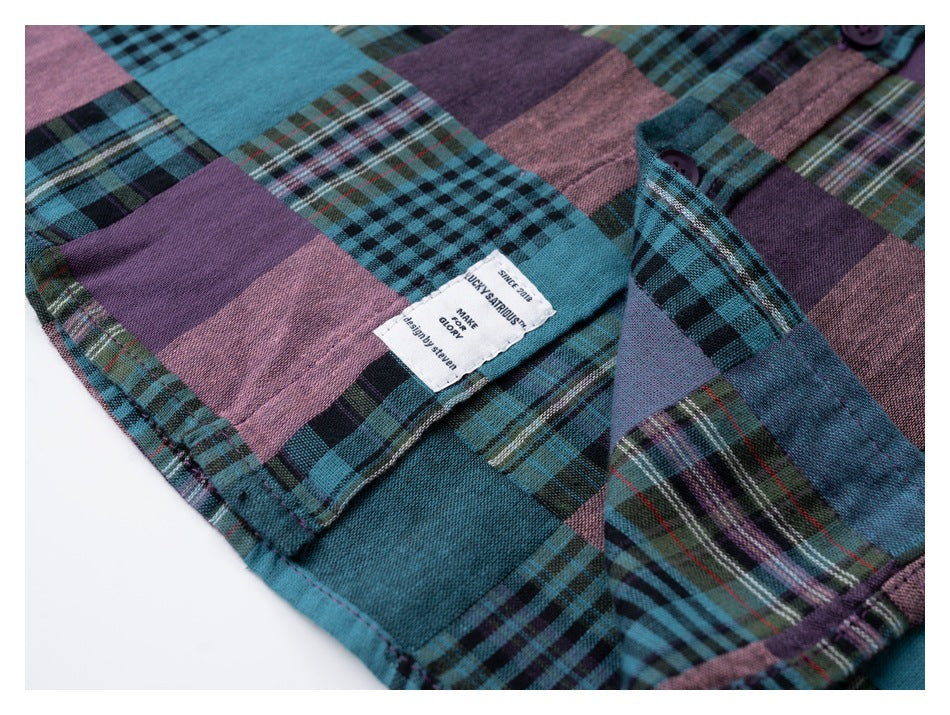 Close-up of the inside label and placket on a teal, purple, and pink plaid shirt.